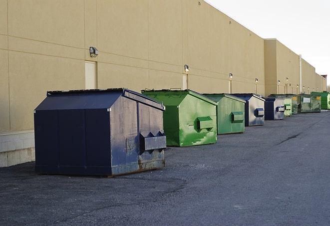 construction workers toss wood scraps into a dumpster in Cazenovia NY